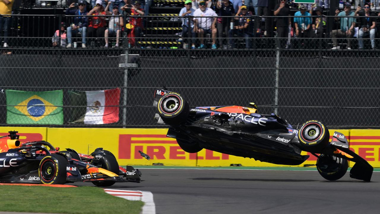 Red Bull Racing's Mexican driver Sergio Perez (R) goes flying in a race-ending crash. Picture: Getty