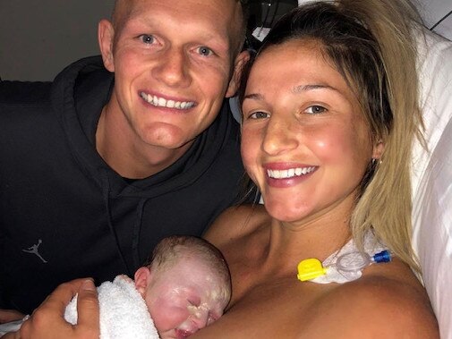 Adam Treloar and Kim Ravaillion with their newborn baby Georgie. Picture: Instagram