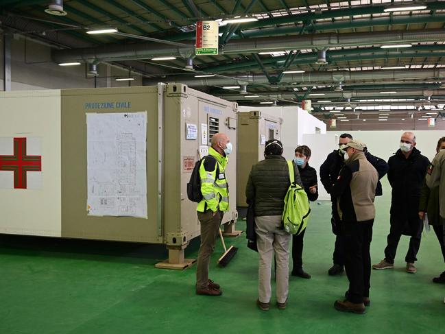 Medical staff and Antonio Tonarelli (C), logistic director of the construction of a 6500sqm field hospital in the premises of the Bergamo Fair, in Italy. Picture: AFP