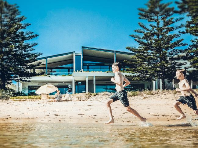 Beau, 10, and Lachlan, 8, Nalevansky run past a beach house at 372 Booker Bay Rd, Booker Bay. that is up for sale. Booker Bay has attracted a surge of buyer interest since the pandemic. Picture: Josef Nalevansky/Imagecloud