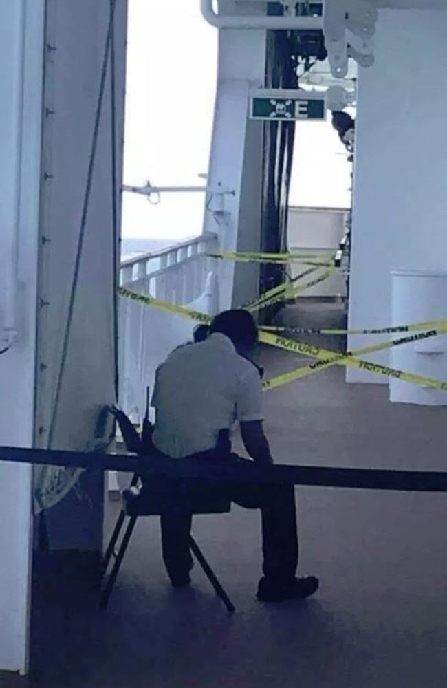 A staff member guards the area where a British tourist went overboard. Picture: Twitter