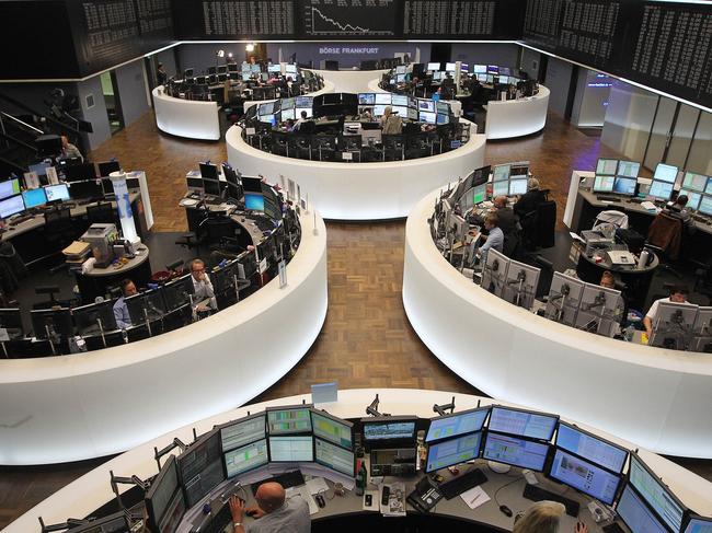 Traders work in front of a board displaying the chart of Germany's share index DAX at the stock exchange in Frankfurt am Main, western Germany, on September 22, 2015. Share prices on the Frankfurt stock exchange fell more than 3.0 percent in midday trading on September 22, 2015, pushed down by index heavyweight Volkswagen, as it ploughed ever deeper into a pollution cheating scandal. AFP PHOTO / DANIEL ROLAND