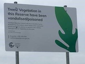 A sign Northern Beaches Council erects if trees have been poisoned or vandalised in a public reserve. Picture: Northern Beaches Council