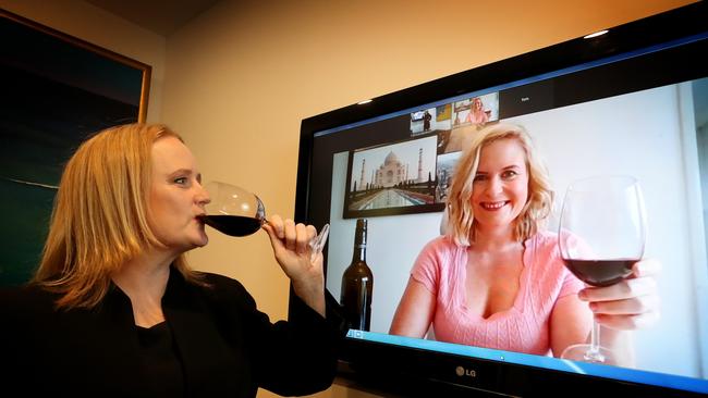 Catriona Macleod has a drink with colleague Laura Thurston who is working from home. Cullen Macleod Lawyers has found a way to preserve the institution of Friday drinks in a coronavirus world. Picture: News Corp