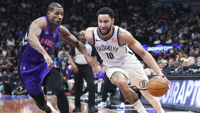 TORONTO, ON - DECEMBER 19: Ben Simmons #10 of the Brooklyn Nets goes to the basket against Ochai Agbaji #30 of the Toronto Raptors during the first half of their basketball game at the Scotiabank Arena on December 19, 2024 in Toronto, Ontario, Canada. NOTE TO USER: User expressly acknowledges and agrees that, by downloading and/or using this Photograph, user is consenting to the terms and conditions of the Getty Images License Agreement. (Photo by Mark Blinch/Getty Images)