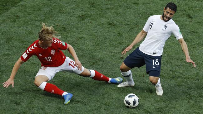 Denmark's Kasper Dolberg, left, and France's Nabil Fekir challenge for the ball. Photo: AP