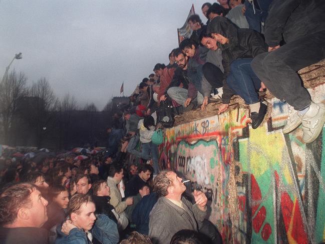 East meets West, at last ... people from East Germany greet citizens of West Germany at the Brandenburg Gate in Berlin, 1989.