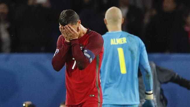 Portugal's Cristiano Ronaldo holds his face after missing a penalty against Austria at Euro 2016.