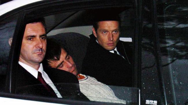 Michael Thorneycroft flanked by detectives after being arrested and charged with conspiracy to murder for the planned hit on Mario Condello. Picture: News Corp