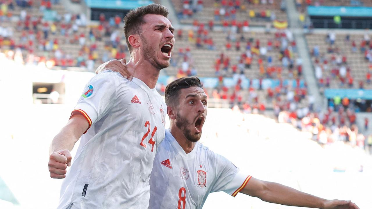 TOPSHOT - Spain's defender Aymeric Laporte (L) celebrates scoring his team's second goal with Spain's midfielder Koke during the UEFA EURO 2020 Group E football match between Slovakia and Spain at La Cartuja Stadium in Seville on June 23, 2021. (Photo by MARCELO DEL POZO / POOL / AFP)