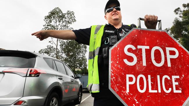 Coomera Police Sergeant Miller part of the Northern Patrols Group  directs traffic to stop and pull over for a Random Breath Test on Rose Valley Drive Upper Coomera.                              Photo Scott Powick Newscorp