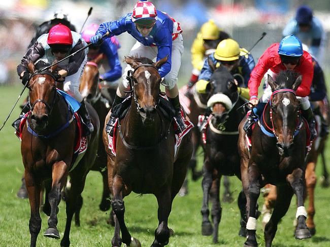 Glen Boss rises in the saddle as Makybe Diva crosses the finish line in the 2005 Melbourne Cup.