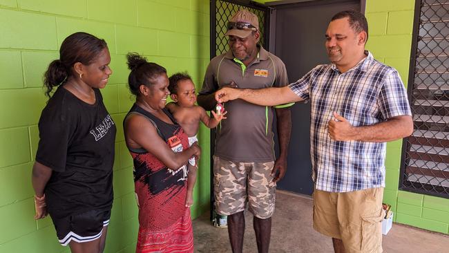 A family receiving keys to their new home by Arafura MLA Manuel Brown. Picture: Supplied.