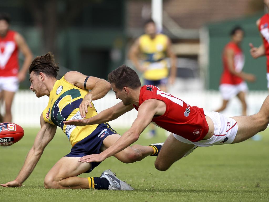 SANFL: Eagles v North Adelaide at Woodville Oval. North's Tom Schwarz dives for the ball with Eagle's Jordan Foote. 31 March 2019. (AAP Image/Dean Martin)