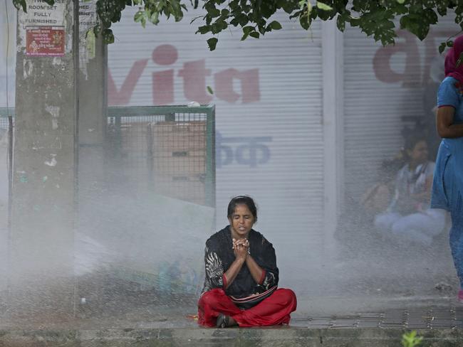 A Dera Sacha Sauda sect supporter braves water cannon used by Indian security forces to disperse violent supporters near a court in Panchkula. Picture: AP