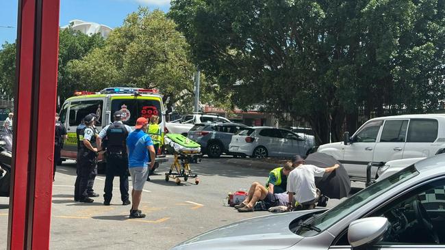 Emergency services at the scene of a vehicle and motorbike crash at Sheridan St, Cairns. Picture: Samuel Davis