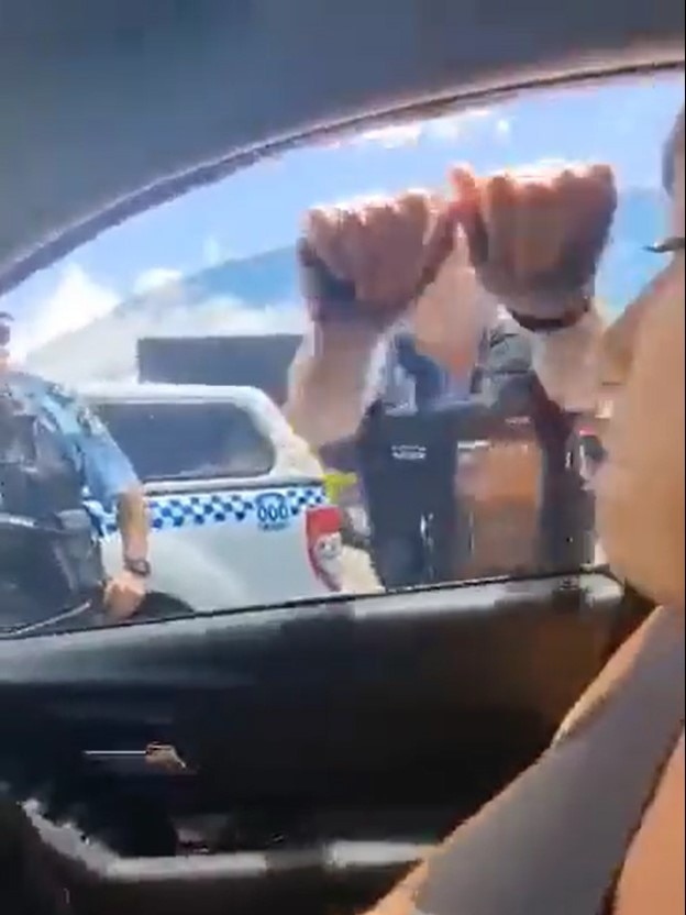 The fed-up officer smashes the car’s window. Picture: Twitter