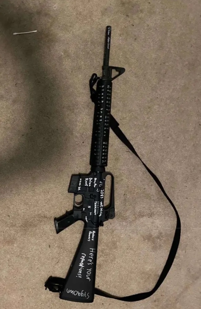 His rifle had racial slurs and ‘Here’s your reparations!’ written on it.