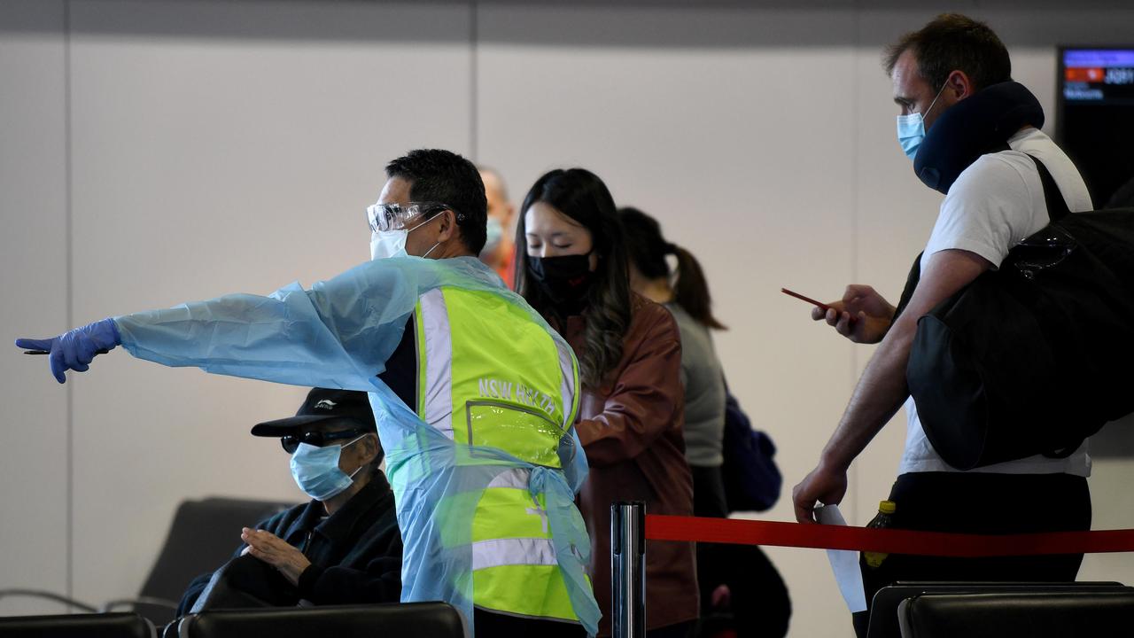 NSW Health workers screen passengers at Sydney airport where an infected woman flew in from Melbourne on July 25. Picture: NewsWire/Bianca De Marchi