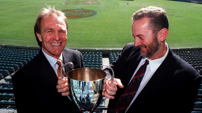 South Australian coach Graham Cornes and his Victorian counterpart Robert Walls hold AFL State of Origin trophy in 1999. Picture: Colin Murty.