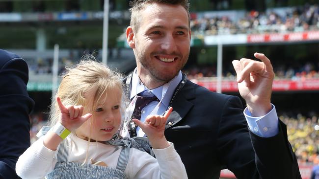 Dale Thomas celebrates his lap of honour with daughter, Tilly. Picture: Michael Klein