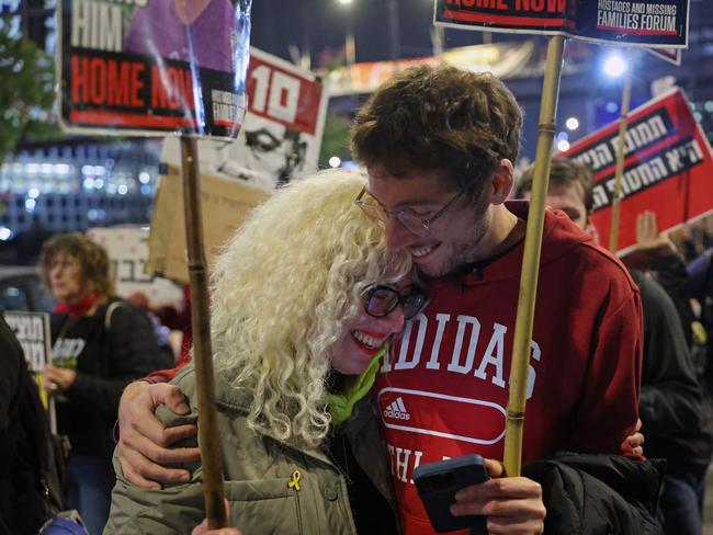 Demonstrators embrace each other as news breaks. Picture: AFP