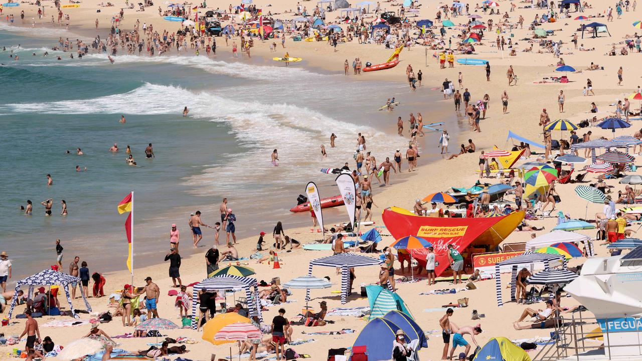 People out at a busy Bondi Beach on a summer Sunday. Picture: Damian Shaw