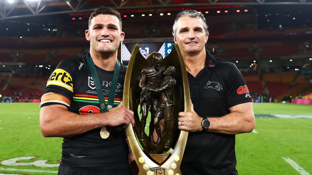 BRISBANE, AUSTRALIA - OCTOBER 03: Nathan Cleary of the Panthers and Panthers coach Ivan Cleary pose with the NRL Premiership Trophy after victory in the 2021 NRL Grand Final match between the Penrith Panthers and the South Sydney Rabbitohs at Suncorp Stadium on October 03, 2021, in Brisbane, Australia. (Photo by Chris Hyde/Getty Images)