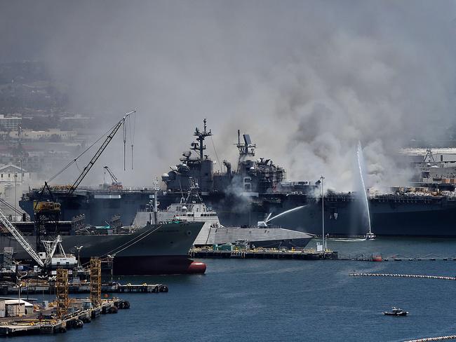 SAN DIEGO, CALIFORNIA - JULY 12: A fire burns on the amphibious assault ship USS Bonhomme Richard at Naval Base San Diego on July 12, 2020 in San Diego, California. There was an explosion on board the ship with multiple injuries reported.   Sean M. Haffey/Getty Images/AFP == FOR NEWSPAPERS, INTERNET, TELCOS & TELEVISION USE ONLY ==