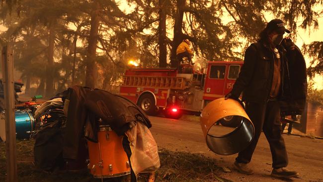 A resident carries personal belongings as Los Angeles County battle the Eaton Fire on January 8. Picture: Justin Sullivan/Getty Images/AFP