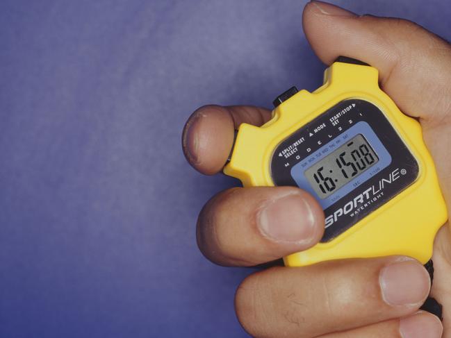Man holding stopwatch, close up of hand, time keeping.