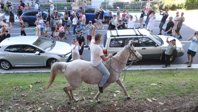 A man was seen riding a horse up and down a street in front of the crowd shouting, “Cross the border. Everyone cross the border, they can’t hold all of us”. Picture: Richard Gosling
