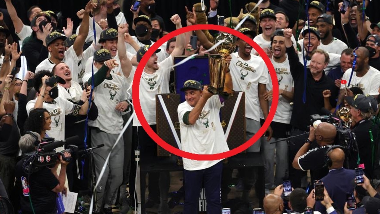 Milwaukee Bucks' Giannis Antetokounmpo holds up the Finals MVP trophy as  confetti falls during a parade celebrating the Milwaukee Bucks' NBA  Championship basketball team Thursday, July 22, 2021, in Milwaukee. (AP  Photo/Aaron