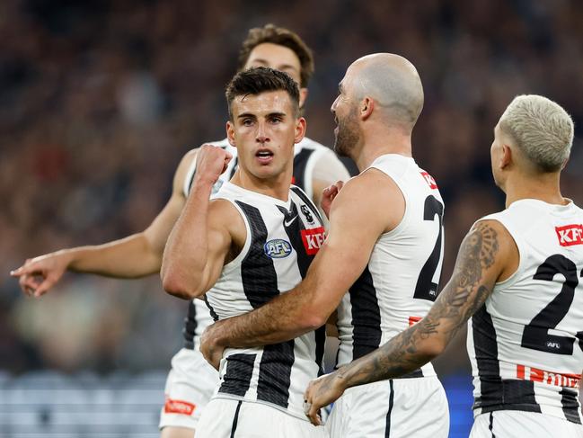 Nick Daicos of the Magpies celebrates a goal with teammate Steele Sidebottom. Picture: Dylan Burns/AFL Photos via Getty Images.