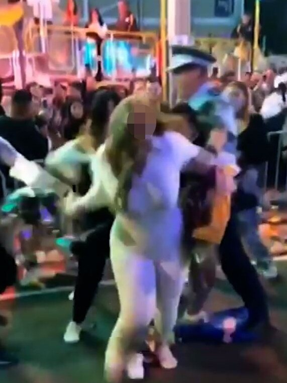 A police officer separating two women during the melee Picture: 2GB