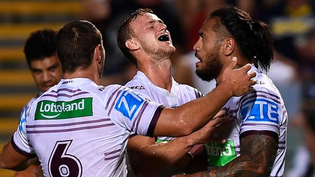 Daly Cherry-Evans celebrates with Manly teammates.