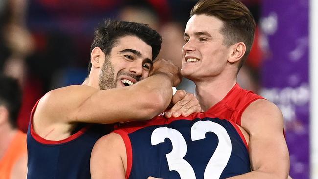 Tom Sparrow is congratulated by Christian Petracca and Bayley Fritsch after kicking a goal. Picture: Getty Images