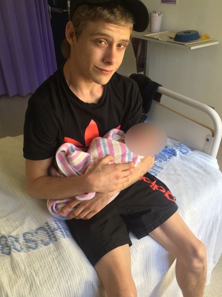 Matthew Leuthwaite holds a baby in 2015.