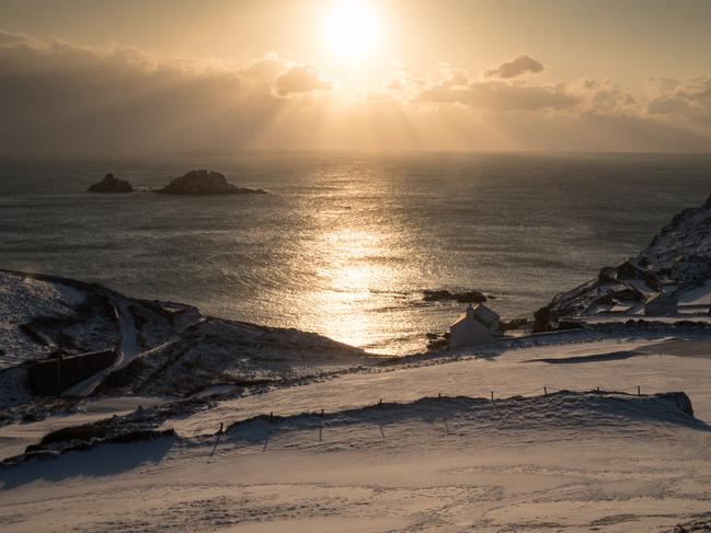 The sun sets as snow covers the fields surrounding Cape Cornwall near Penzance on February 28, 2018 in Cornwall, England. Freezing weather conditions dubbed the “Beast from the East” has brought snow and sub-zero temperatures to many parts of the UK. Amber warnings are in place in northern England, the East Midlands, London, the d south-east of England. Scotland’s weather warning has been upgraded to red, which meansby. Picture: Getty Images