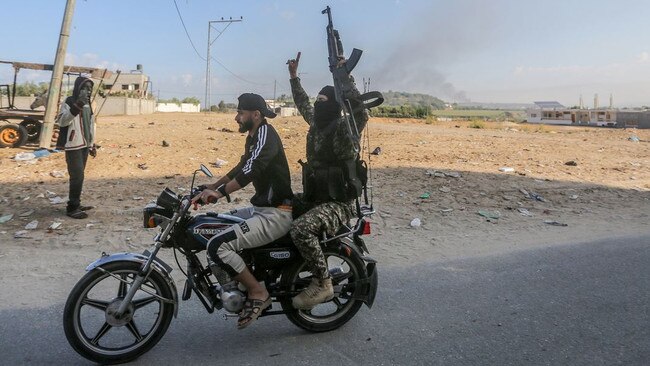 An armed Palestinian raises his weapon as he rides a motorbike at the northern edge of Gaza after Hamas attacked Israel, Oct. 7. Picture: Zuma Press