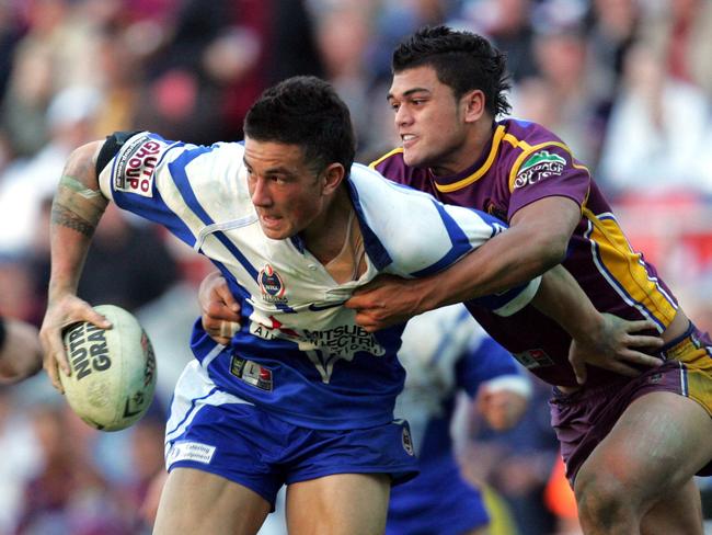 Sonny Bill Williams tackled by Karmichael Hunt when playing for the Bulldogs in 2004. Picture: Darren/England