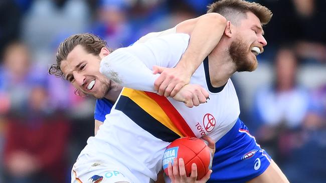 NABBED: Bryce Gibbs is tackled by Western Bulldogs star Marcus Bontempelli in this year’s round 23 match in Ballarat. Picture: QUINN ROONEY (Getty Images).