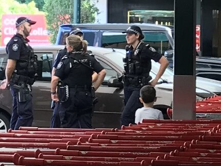 Police at Coles in New Farm as shelves are re-stocked. Picture: Andrea Macleod