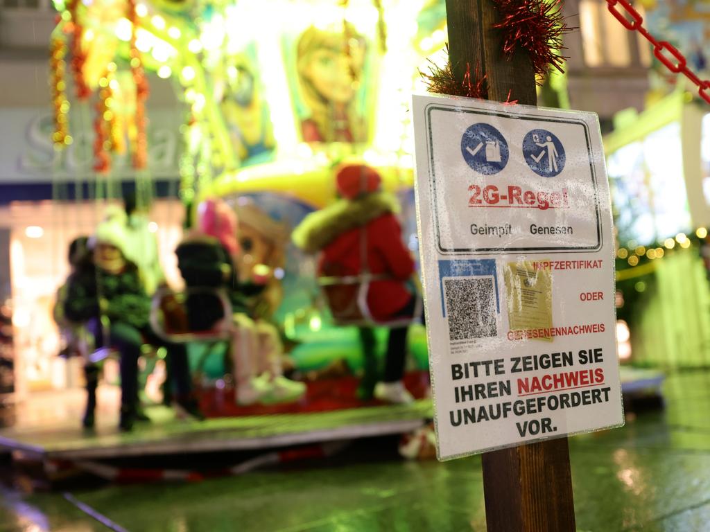 A sign in front of a children’s carousel at a Christmas market in Hagen, Germany, says only people who are vaccinated or recently recovered from Covid-19 may enter. Picture: Andreas Rentz/Getty Images