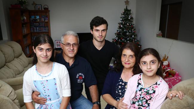 Moussa Seecy with wife Tina, son Marcus, 18, and daughters Marian, 11, and Mariah, 9, at home in Sydney. Picture: John Feder