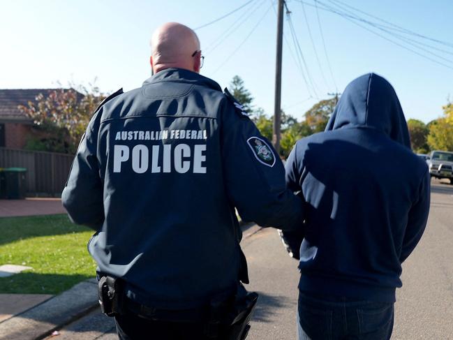 An AFP officer arrests a suspect allegedly involved in use of the Ghost communications app. Picture: Australian Federal Police