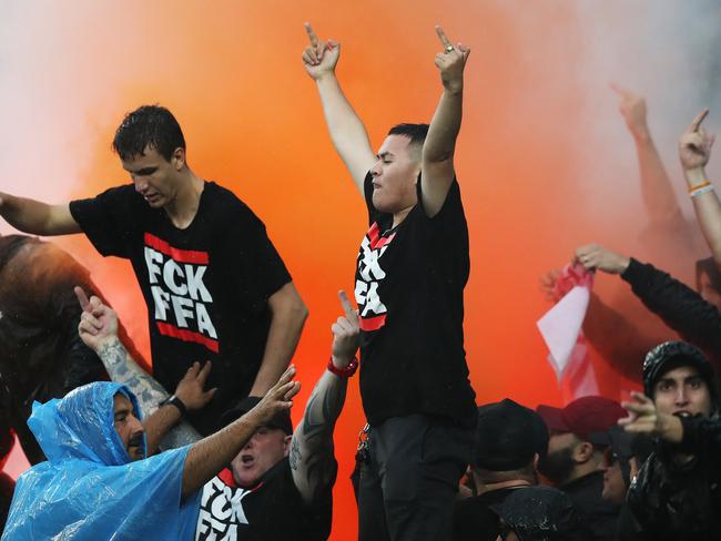Wanderers fans light a flare during the Sydney Derby.