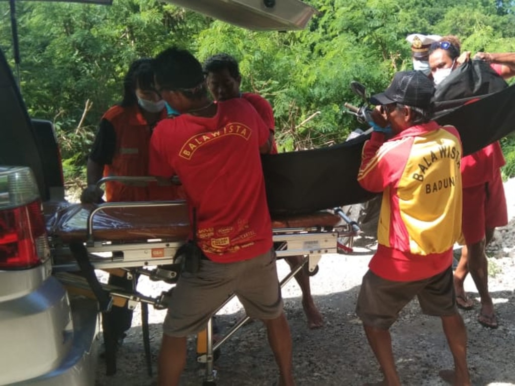 Emergency workers remove the man’s body. Picture: Supplied