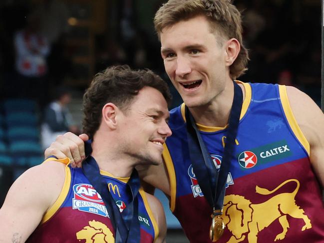 Brisbane Lions captains Lachie Neale and Harris Andrews together on the dais after winning the 2024 AFL Premiership. Picture Lachie Millard