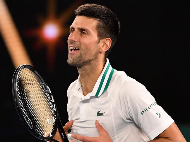 Serbia's Novak Djokovic celebrates winning against Russia's Aslan Karatsev during their men's singles semi-final match match on day eleven of the Australian Open tennis tournament in Melbourne on February 18, 2021. (Photo by William WEST / AFP) / -- IMAGE RESTRICTED TO EDITORIAL USE - STRICTLY NO COMMERCIAL USE --